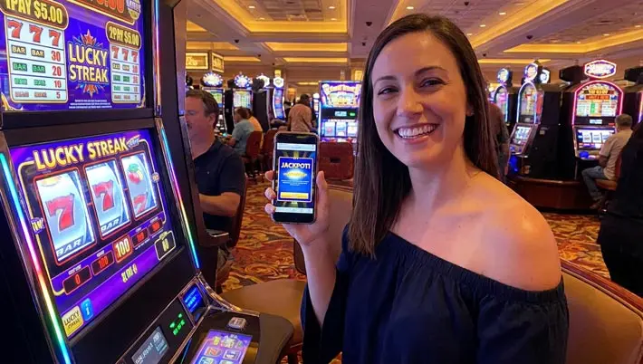 une femme souriante regardant son téléphone portable